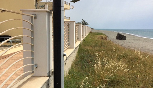 Beachfront apartment in prime position with rooftop terrace, balcony and patio.